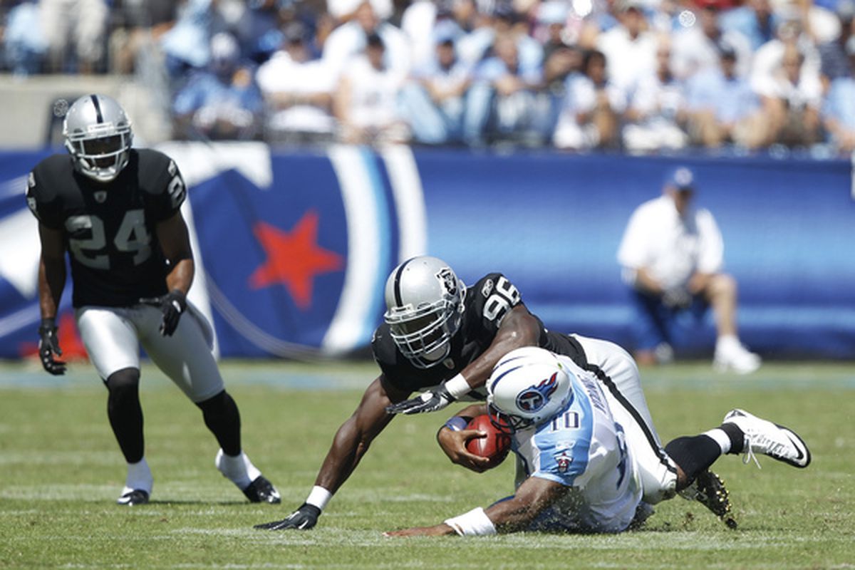Kamerion Wimbley #96 of the Oakland Raiders tackles Vince Young #10 of the Tennessee Titans