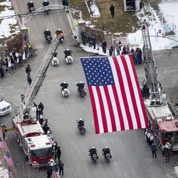 The procession begins to enter the Spanish Fork Cemetery following funeral services for Utah County Sheriff's Sgt. Cory Wride Wednesday, Feb. 5, 2014.