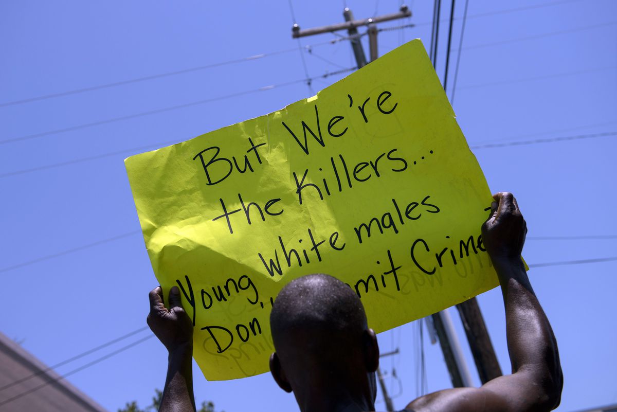 A man holds up a sign after a vigil outside Morris Brown AME Church (BRENDAN SMIALOWSKI/AFP/Getty)