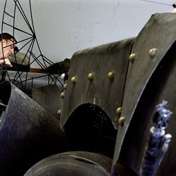 Kirk Jellum puts the front piece onto his large-scale scorpion at his shop in Salt Lake City on Wednesday, Sept. 26, 2012. A large-scale kinetic sculpture of a praying mantis that was created by Jellum was purchased by the owner of Zappos.com, an online shoe and apparel shop.