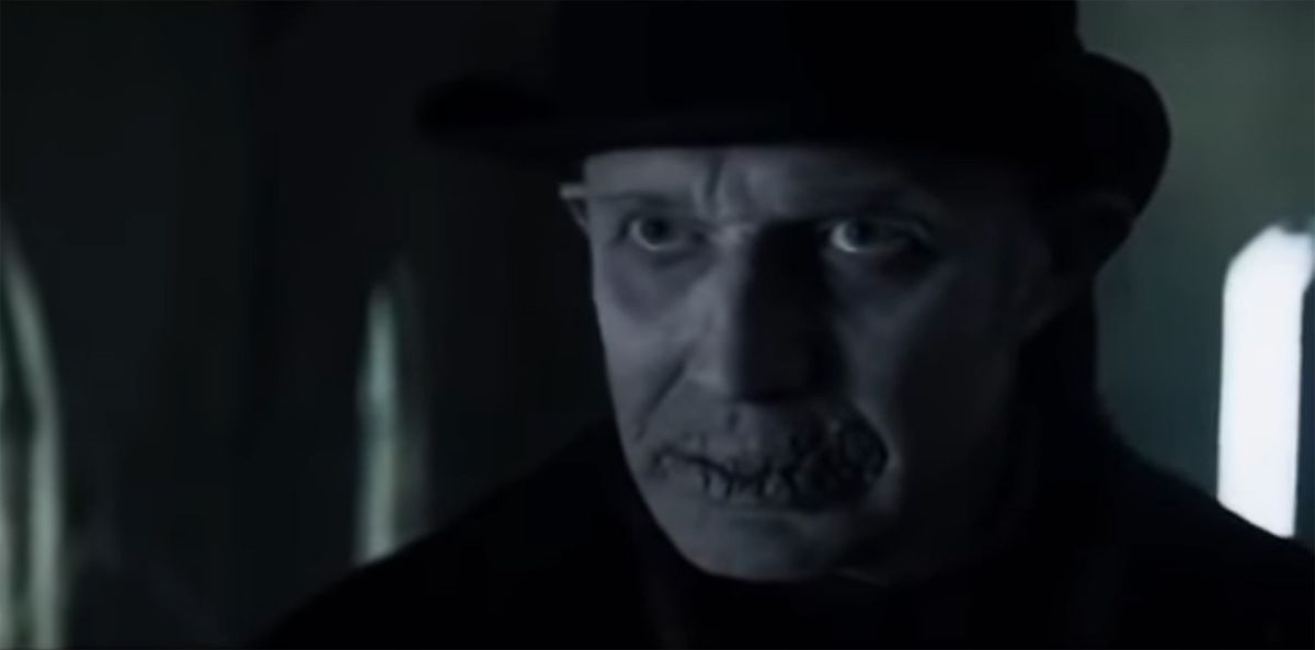 Jason Flemyng playing a ghost of christmas yet to come with his mouth sewen shut and a top hat