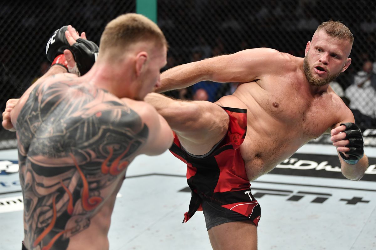 (R-L) Marcin Tybura of Poland kicks Alexander Volkov of Russia in a heavyweight fight during the UFC 267 event at Etihad Arena on October 30, 2021 in Yas Island, Abu Dhabi, United Arab Emirates.