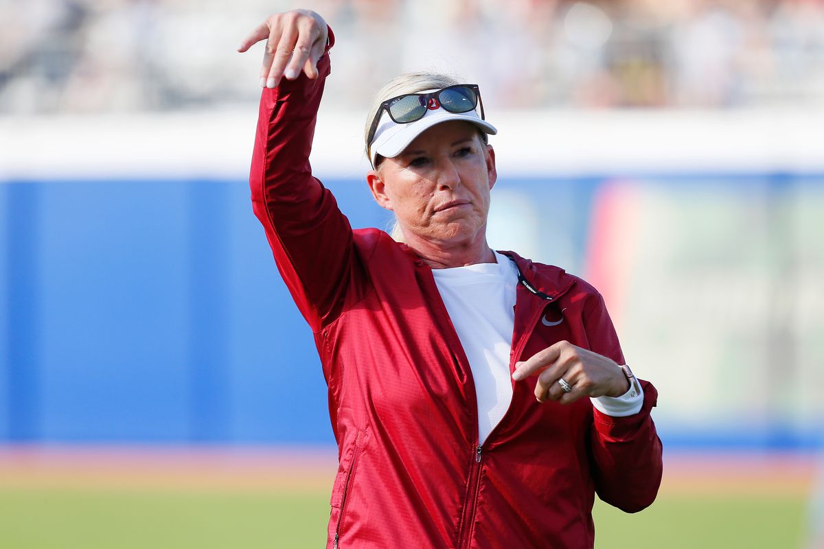 Head coach Patty Gasso of the Oklahoma Sooners tosses balls before the second game against the Texas Longhorns during the NCAA Women’s College World Series finals at the USA Softball Hall of Fame Complex on June 9, 2022 in Oklahoma City, Oklahoma.