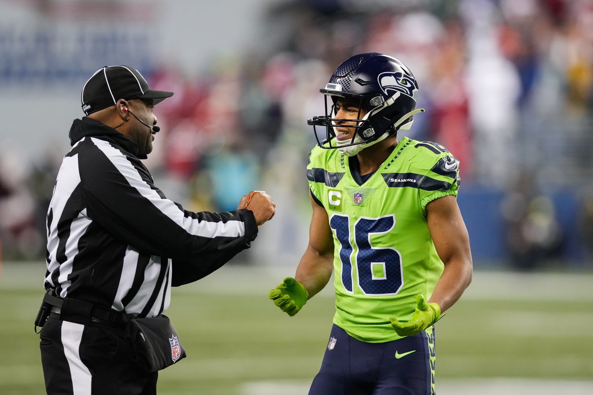 Tyler Lockett #16 of the Seattle Seahawks talks with a referee during the first quarter of a game against the San Francisco 49ers at Lumen Field on December 15, 2022 in Seattle, Washington.