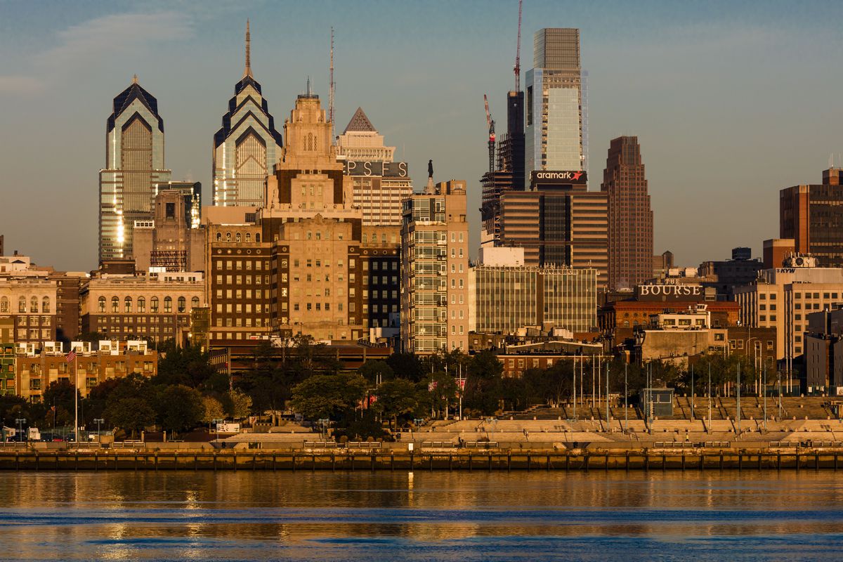 The skyscrapers of Philadelphia rise above the Delaware River at sunrise
