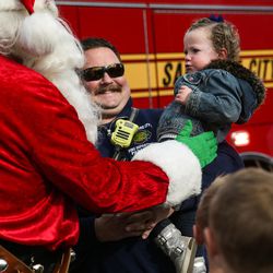 Salt Lake City Fire Capt. Jeff Kauffmann and his daughter, Laini, 2, say hello to Santa Claus at the Sugar House Santa Shack in Salt Lake City on Saturday, Nov. 26, 2016.