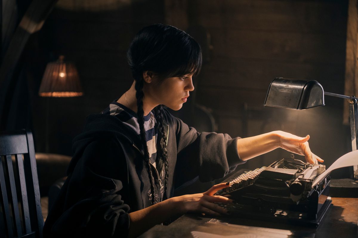 fourth, a girl with braided black hair, hunched over a typewriter in a dimly lit room 