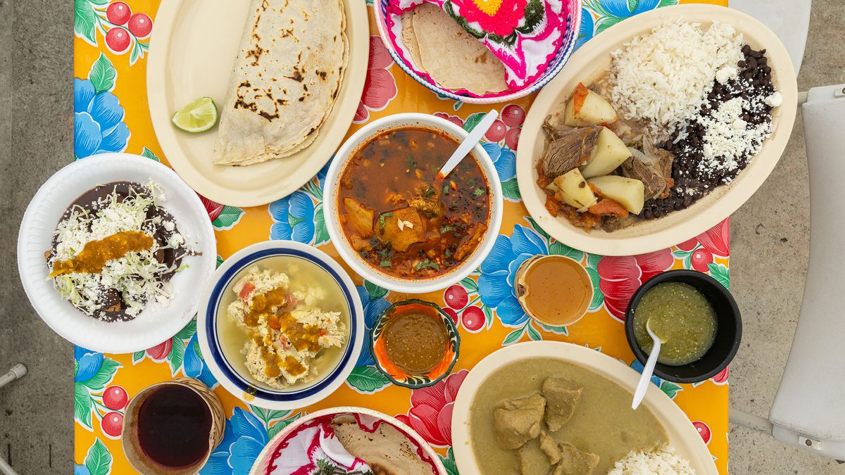 Traditional Oaxacan dishes are laid out on a colorful table at Comedor Tenchita.