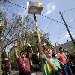 Collin Cancienne, 9, of Metairie hopes riders can fill his Mardi Gras box with throws as the Krewe of Mid-City rolls on the Uptown route in New Orleans Sunday, March 3, 2019, to the theme, ëMid-City Thinks Outside the Box.í Patricia Braswell Murray reigned as Queen Mid-City LXXXVI over the clubís 200 male members on 17 floats. Founded in 1933, the Krewe of Mid-City is the 5th-oldest continuously parading organization of the New Orleans Mardi Gras season.  (Scott Threlkeld/The Advocate via AP)