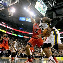Utah Jazz power forward Derrick Favors (15) works to the basket as Chicago Bulls center Joakim Noah (13) defends during a game at EnergySolutions Arena on Monday, Nov. 25, 2013.