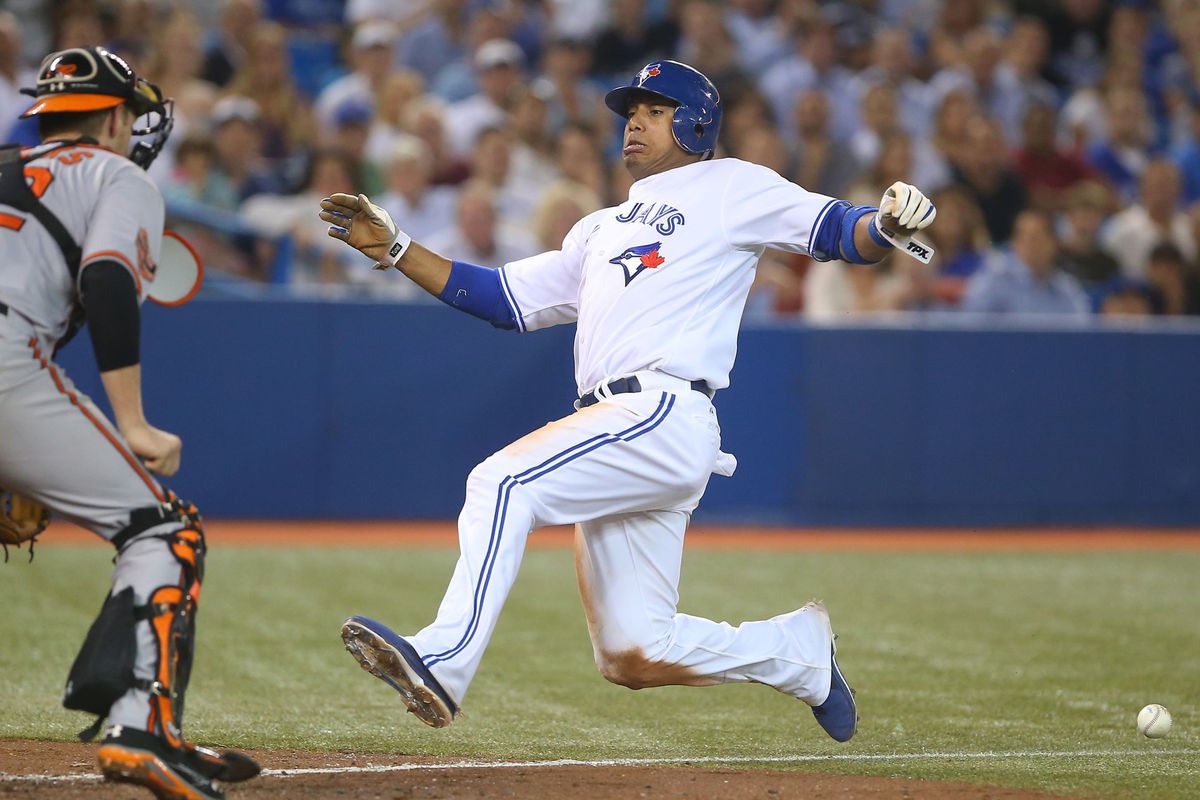 Sep 5, 2012; Toronto, ON, Canada; Toronto Blue Jays shortstop Yunel Escobar (5) scores the go-ahead run in the seventh inning on a suicide squeeze against the Baltimore Orioles at the Rogers Centre. Mandatory Credit: Tom Szczerbowski-US PRESSWIRE