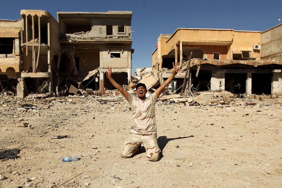 A pro-government fighter in Benghazi celebrates victory.