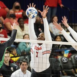 Utah’s Zoe Weatherington, left, and Allie Olsen jumps to block a shot by UVU’s Tori Dorius in an NCAA volleyball game at Smith Fieldhouse in Provo on Friday, Dec. 3, 2021.