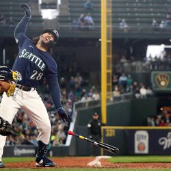 Eugenio Suarez #28 of the Seattle Mariners reacts after being hit by a pitch during the ninth inning against the Milwaukee Brewers at T-Mobile Park on April 19, 2023 in Seattle, Washington.