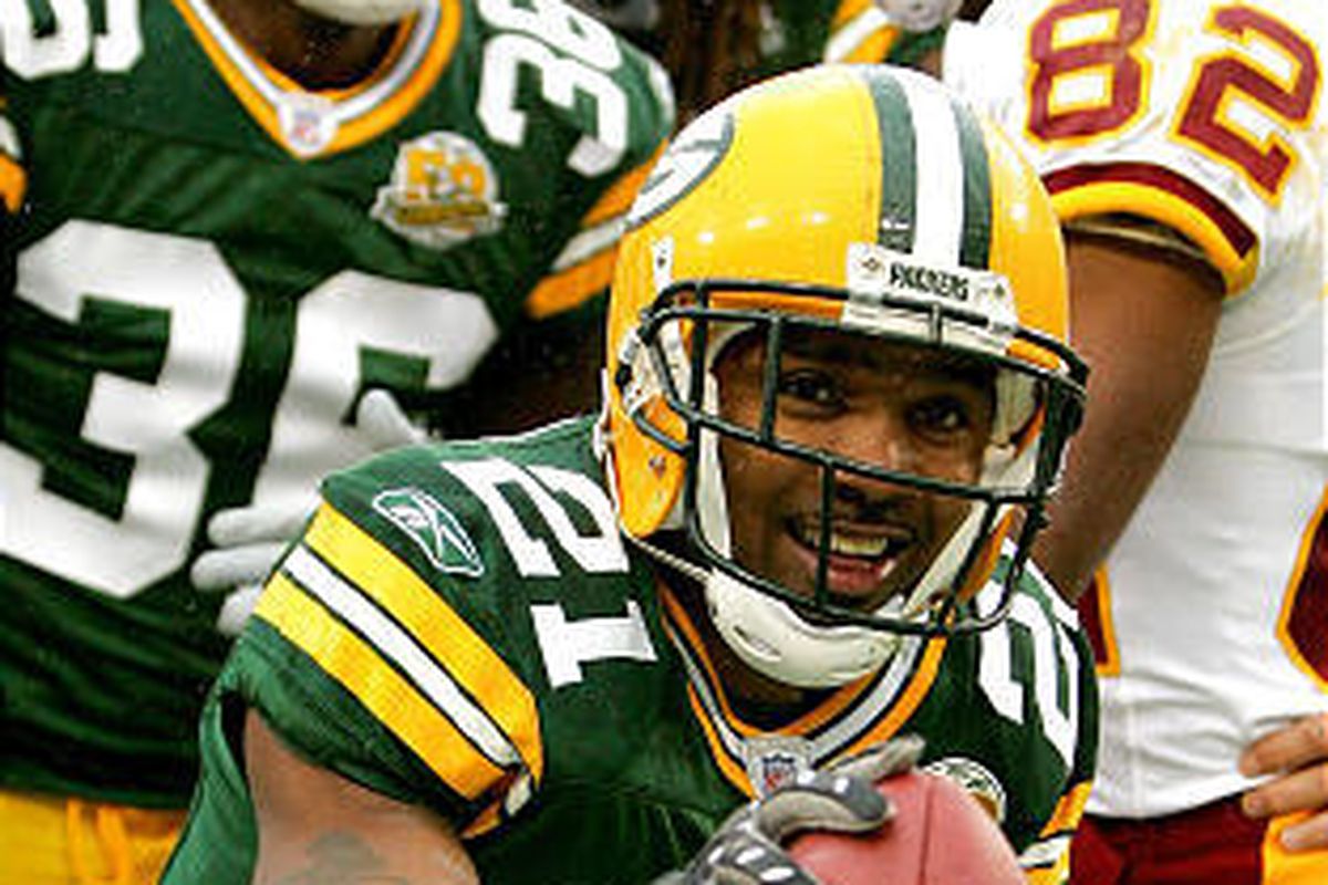 Green Bay's Charles Woodson celebrates his touchdown on a fumble return against the Redskins.