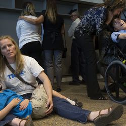 Heather Nelson comforts her son, Matthew, 10, after he collapsed from having a seizure during a press conference at the Utah State Office Building in Salt Lake City on Thursday, Aug. 23, 2018, where a broad coalition of Utah community leaders announced its opposition to Utah's medical marijuana ballot initiative. Nelson gives her son cannabis, which she says reduces the frequency of his seizures from 50 a day to five a day. Members of TRUCE, Together For Responsible Use and Cannabis Education, took opposition to what was said during the press conference by turning their backs to the speakers,
