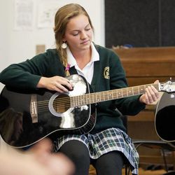 Amanda Higgs, a senior at St. Joseph Catholic High School in Ogden, attends her music class Wednesday, Oct. 1, 2014, learning to play the guitar.