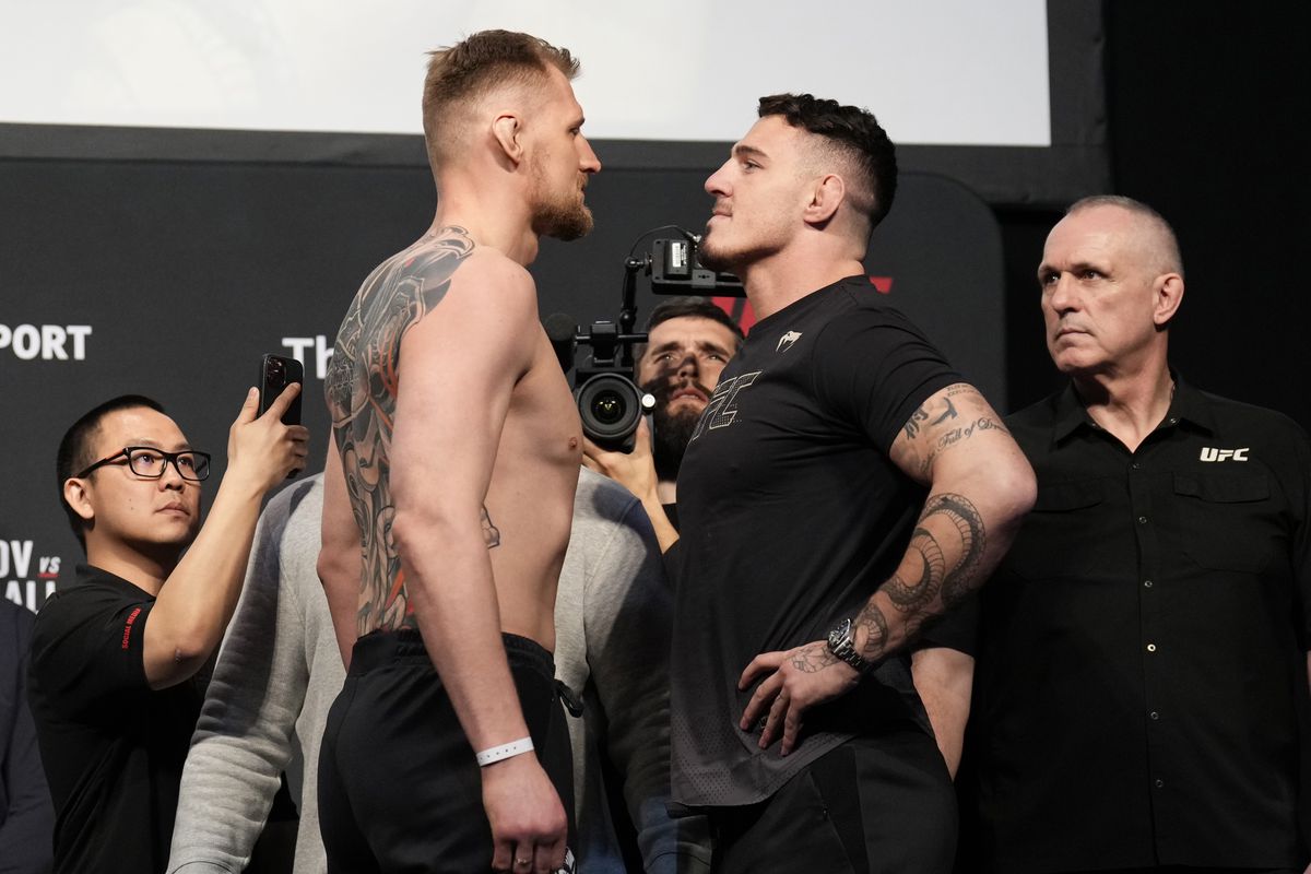 (L-R) Opponents Alexander Volkov of Russia and Tom Aspinall of England face off during the UFC Fight Night ceremonial weigh-in at O2 Arena on March 18, 2022 in London, England.