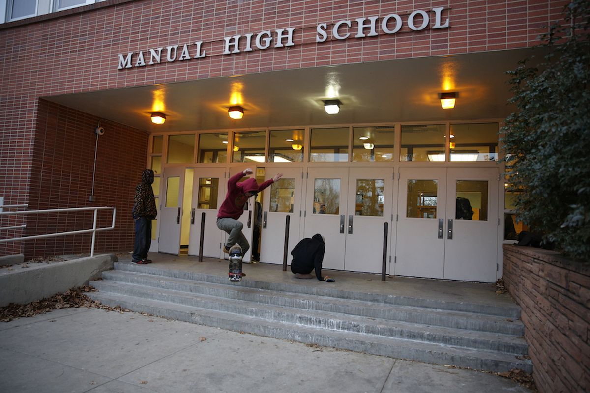 A student skateboards across an entrance at Manual High School. Throughout the much success has been promised the school in northeast Denver with little to show for it.