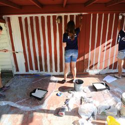 U.S. Bank employees and folks from NeighborWorks Salt Lake paint a home in Salt Lake City as part of the organization's annual Paint Your Heart Out event on Friday, Aug. 11, 2017.