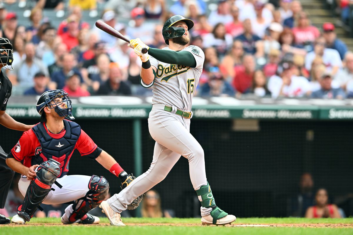 Seth Brown #15 of the Oakland Athletics hits a grand slam during the seventh inning against the Cleveland Guardians at Progressive Field on June 11, 2022 in Cleveland, Ohio.