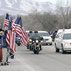 The procession makes its way to Spanish Fork City Cemetery for the interment service for Utah County Sheriff's Sgt. Cory Wride on Wednesday, Feb. 5, 2014.