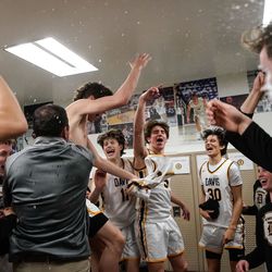 Davis High players cheer after winning the Northern Utah Shootout championship game against Olympus at Davis High School in Kaysville on Saturday, Dec. 11, 2021.
