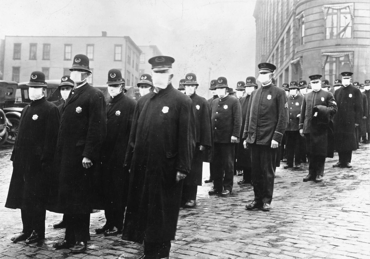 Seattle policemen are photographed wearing masks made by the Red Cross during the influenza epidemic in December 1918.