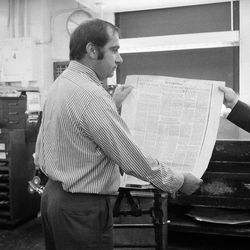 In this June 30, 1971 file picture, workers in the New York Times composing room in New York look at a proof sheet of a page containing the secret Pentagon report on Vietnam. 