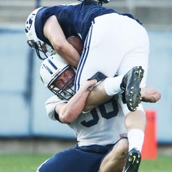 BYU's Tanner Balderree (98) tackles Brigham Young Cougars wide receiver Trey Dye (86) during the Spring football game in Provo  Friday, March 27, 2015. 