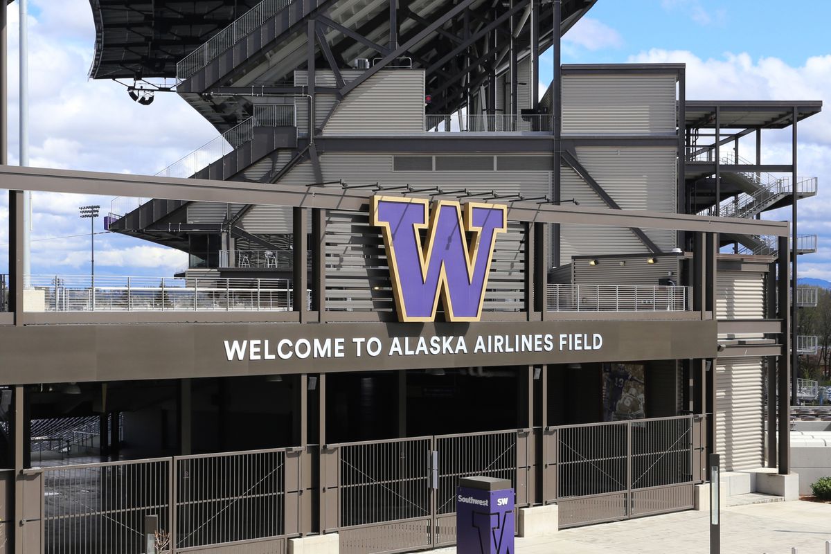 The exterior of Husky Stadium, which has the school’s purple “W” logo out front along with a sign that says “Welcome to Alaska Airlines Field”