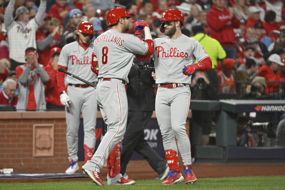 Philadelphia Phillies designated hitter Bryce Harper celebrates his home run with right fielder Nick Castellanos in the second inning against the St. Louis Cardinals during game two of the Wild Card series for the 2022 MLB Playoffs at Busch Stadium.