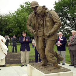 In this Sunday, June 3, 2001 photo, Eugene Kapaun, left, and Bishop Eugene Gerber look at the statue honoring Chaplain Emil Kapaun at its unveiling at St. John Nepomucene Church in Pilson, Kan. Kapaun served in the Korean War and died in a prisoner of war camp on May 23, 1951. Soldiers who knew him never forgot the plain-spoken chaplain who urged them to keep their spirits up and is credited with saving hundreds of soldiers during the Korean War. On April 11, 2013, President Barack Obama will award Kapaun the Medal of Honor posthumously. 