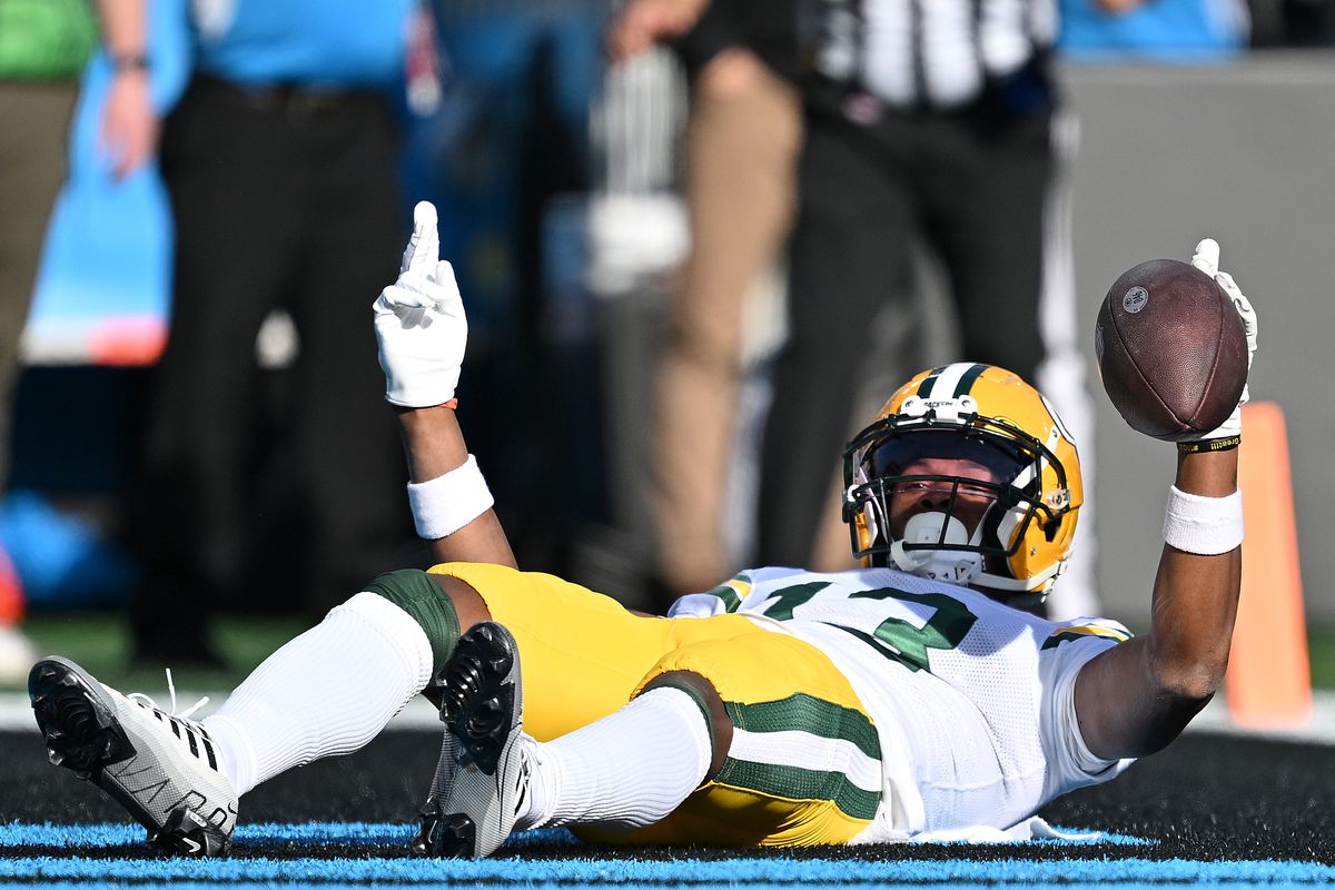Dontayvion Wicks #13 of the Green Bay Packers reacts after scoring a touchdown during the second quarter against the Carolina Panthers at Bank of America Stadium on December 24, 2023 in Charlotte, North Carolina.