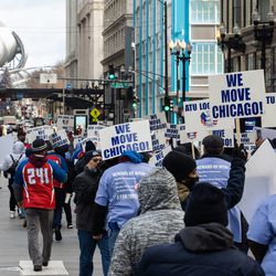 Dozens of Chicago Transit Authority bus operators, Amalgamated Transit Union 241 members and their allies march along East Washington Street in the Loop, Saturday morning, Dec. 11, 2021 to demand the city to protect transit workers. This is in response to what they say is an increased number of assaults against bus operators in the city. | Pat Nabong/Sun-Times