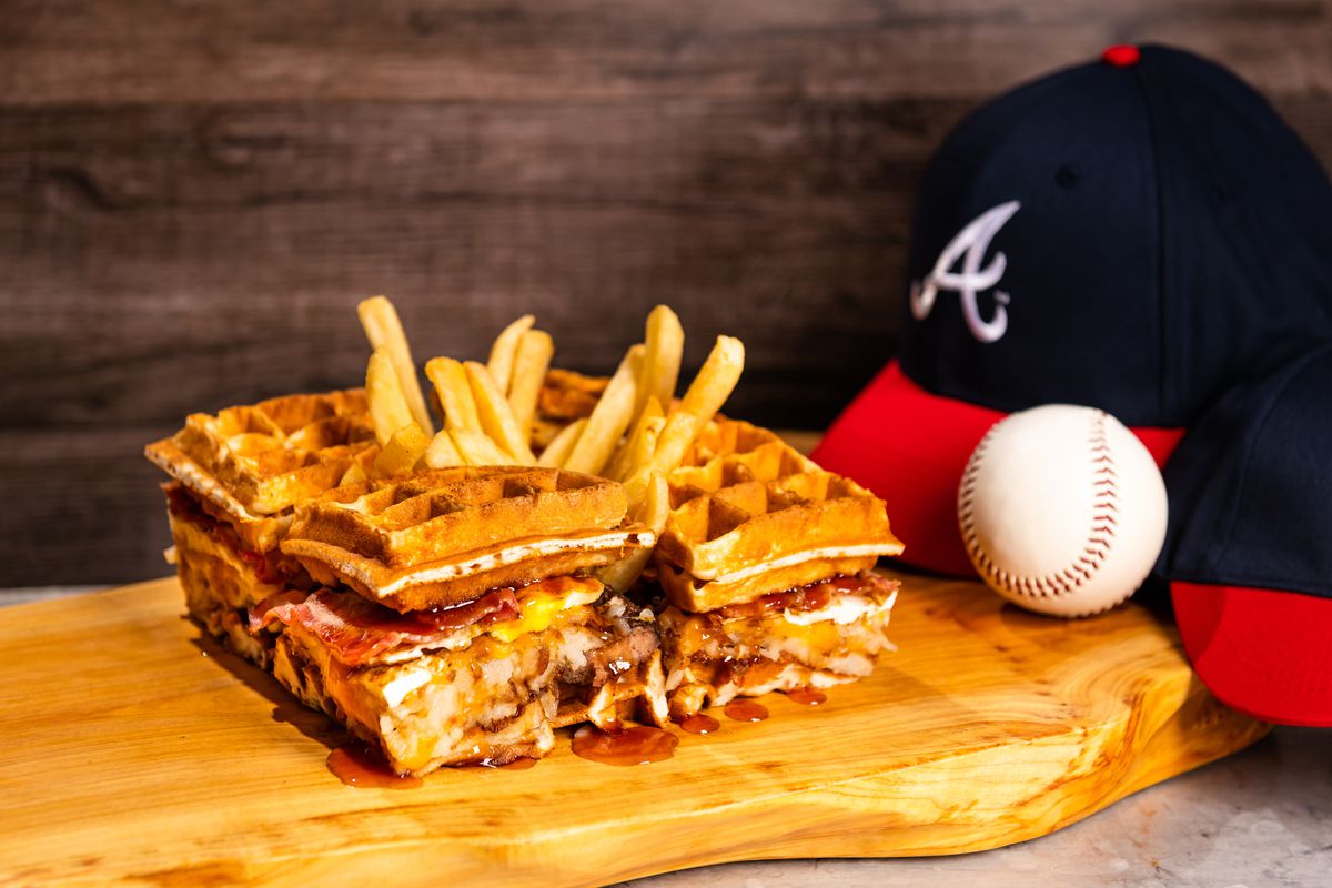 A four grilled beef patty burger topped with bacon, cheese, a sunny egg sandwiched between waffles from Braves Truist Park Stadium in Georgia.