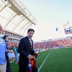 Dean Bullock, 59, is honored at a Real Salt Lake game recently for his efforts to earn a chance to compete in the Ironman World Championship in Kona, Hawaii, through Kona Inspired, a program that allows athletes to compete because they epitomize the idea that "anything is possible."