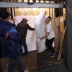 Morgan Covington, a student in the Rescue Mission of Salt Lake's recovery program, helps move new mattresses, donated by Leesa Sleep, to the dorm at the mission on World Homeless Day in Salt Lake City on Wednesday, Oct. 10, 2018.