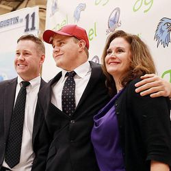 Salem Hills' Porter Gustin stands with his parents John and Scarlett after his announcement Tuesday, Feb. 3, 2015, that he will be playing for the USC Trojans, during an event at the school with family, friends and coaches around.