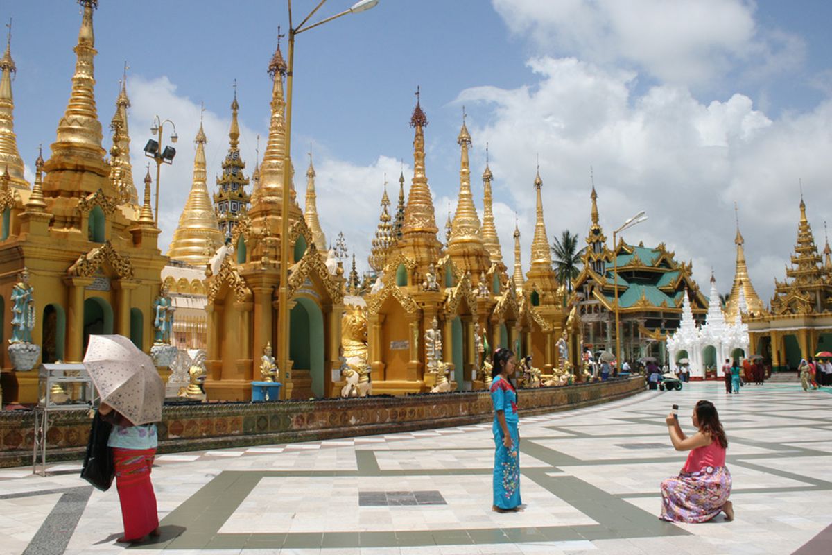 Visitors to the Shwedagon Pagoda grounds in Yangon, Myanmar, snap photos. Photo by Kristi Eaton.