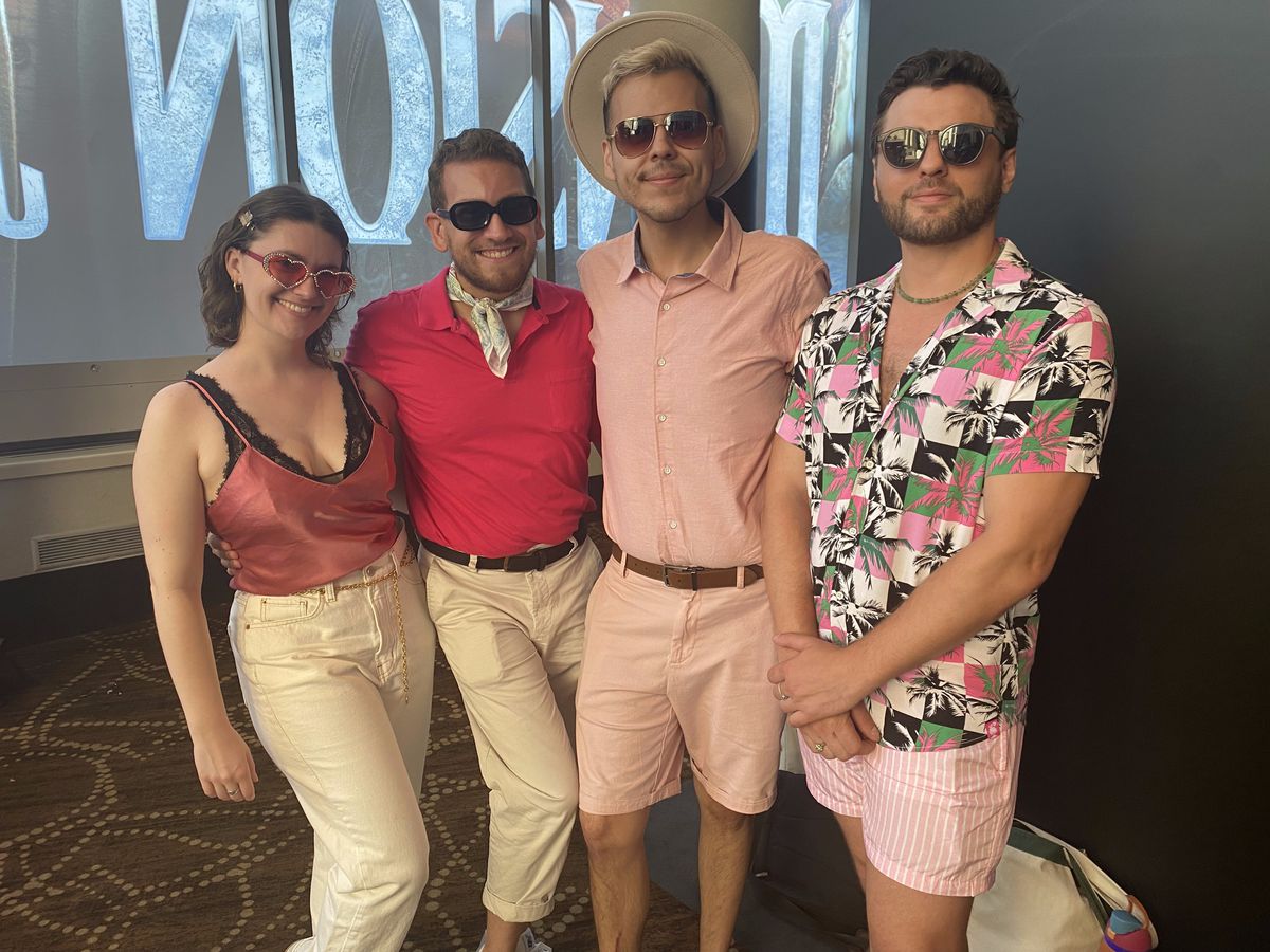 A group of four people dressed in pink outfits for Barbie
