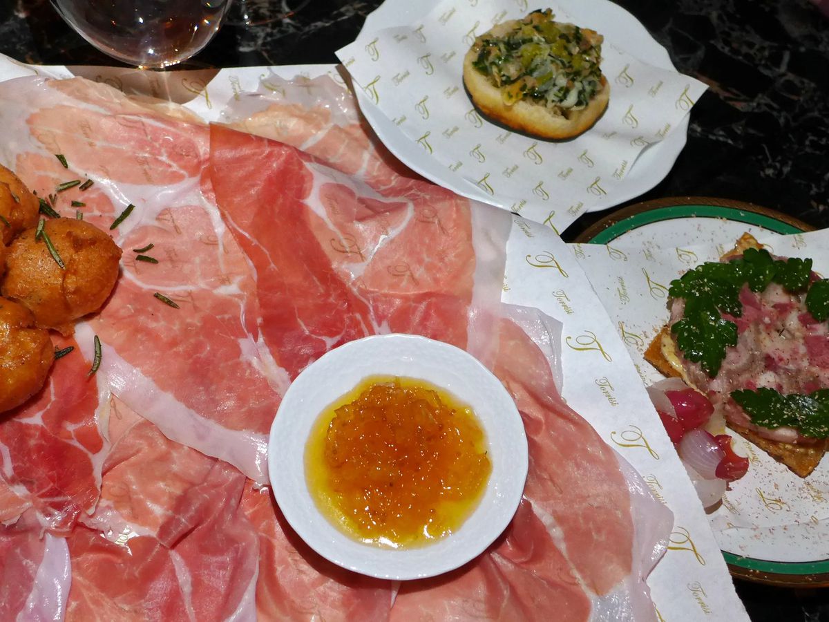 Ham and other small plates on a table.