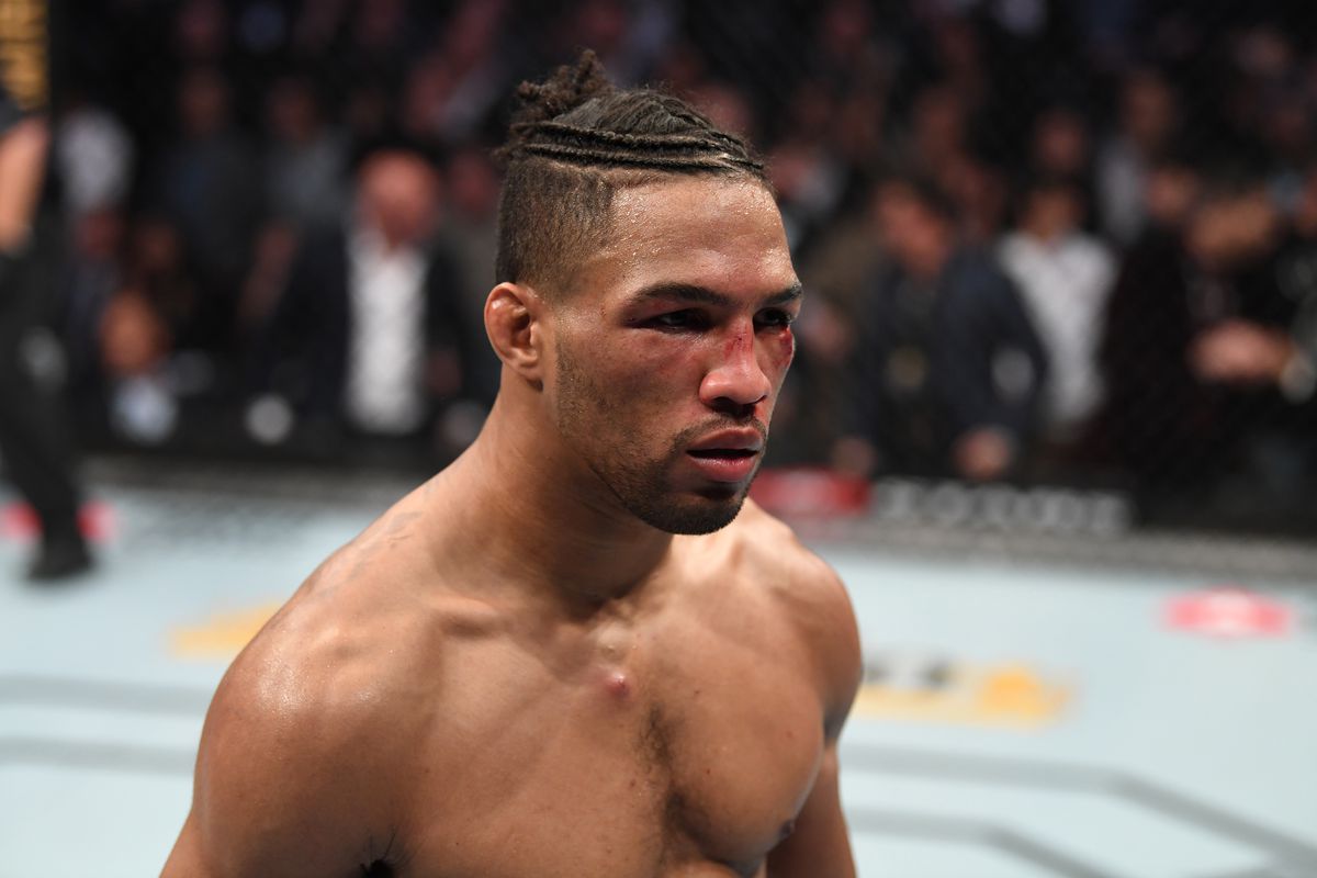 Kevin Lee poses in the cage after his KO victory over Gregor Gillespie at UFC 244.
