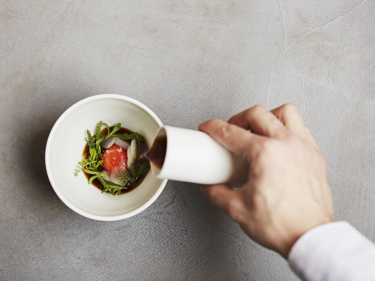 A sauce being poured over a bowl at Roganic in Marylebone