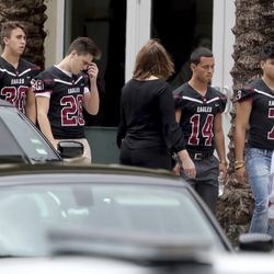 Mourners attend the funeral service for Marjory Stoneman Douglas High School assistant football coach, Aaron Feis. at the Church by the Glades in Coral Springs, Fla., Thursday, Feb. 22. 2018. Football players wearing Stoneman Douglas jerseys carried Feis' casket into the service at the church where family and friends gathered to remember him as loyal and caring. (Mike Stocker/South Florida Sun-Sentinel via AP)