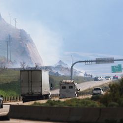 Traffic moves west as fire crews work to put out a brush fire along I-80 east of Tooele on Sunday, July 7, 2019. The fire caused long traffic delays Sunday afternoon.