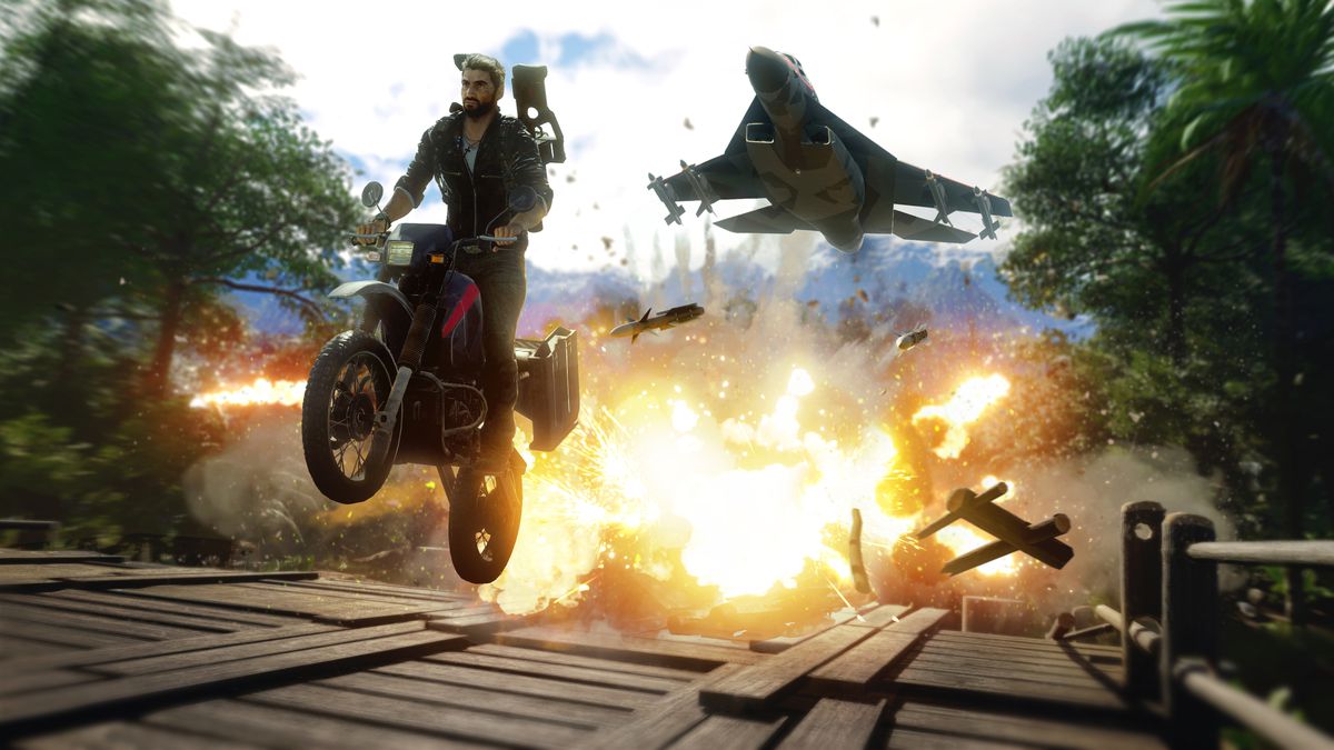 Just Cause 4 - Rico riding a motorcycle across a wooden bridge with an explosion going off behind him as a fighter jet chases him