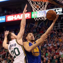 Golden State Warriors guard Klay Thompson (11) reaches for a basket as Utah Jazz forward Gordon Hayward (20) defends in the second half of an NBA regular season game at the Vivint Arena in Salt Lake City, Wednesday, March 30, 2016.
