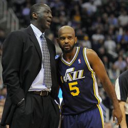 Utah Jazz head coach Tyrone Corbin and Utah Jazz point guard John Lucas III (5) converse during a Lakers free throw attempt during a game at EnergySolutions Arena on Friday, Dec. 27, 2013.