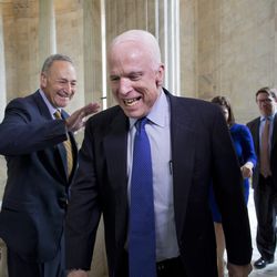 Sen. John McCain laughs as he and Sen. Chuck Schumer cross paths on Capitol Hill. Leaders of both parties have been quick to praise Sen. John McCain as a rare statesman who made friends on both sides of the aisle. 